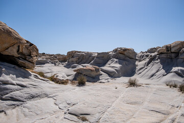 Wall Mural - Granite grey rocks shaped by the sea salt and wind background. Kolymbithres Paros island Greece.