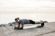 © Westend61 - Male athlete with headphones exercising plank position on exercise mat