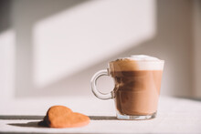 Glass Of Foamy Coffee With Heart Shaped Biscuits Served On Table