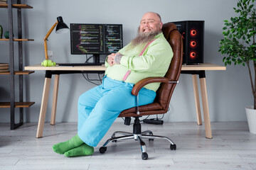 Profile side view portrait of attractive cheerful guy ceo boss chief tech manager sitting in chair at office indoor workplace station