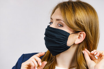 Wall Mural - Woman using protective face mask.