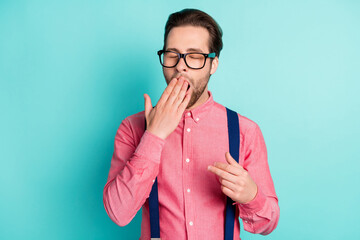 Poster - Photo of young bored exhausted man yawn sleepy cover hand mouth face isolated on teal color background