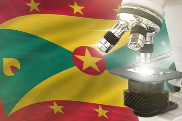 Wall Mural - Grenada science development concept - microscope on flag background. Research in pharmaceutical industry or biology 3D illustration of object