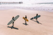 © Cavan Images - Group of women with surfboards at the beach
