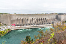 View Of A Large Dam For Electricity Generation Along A River On A Cloudy Autumn Day