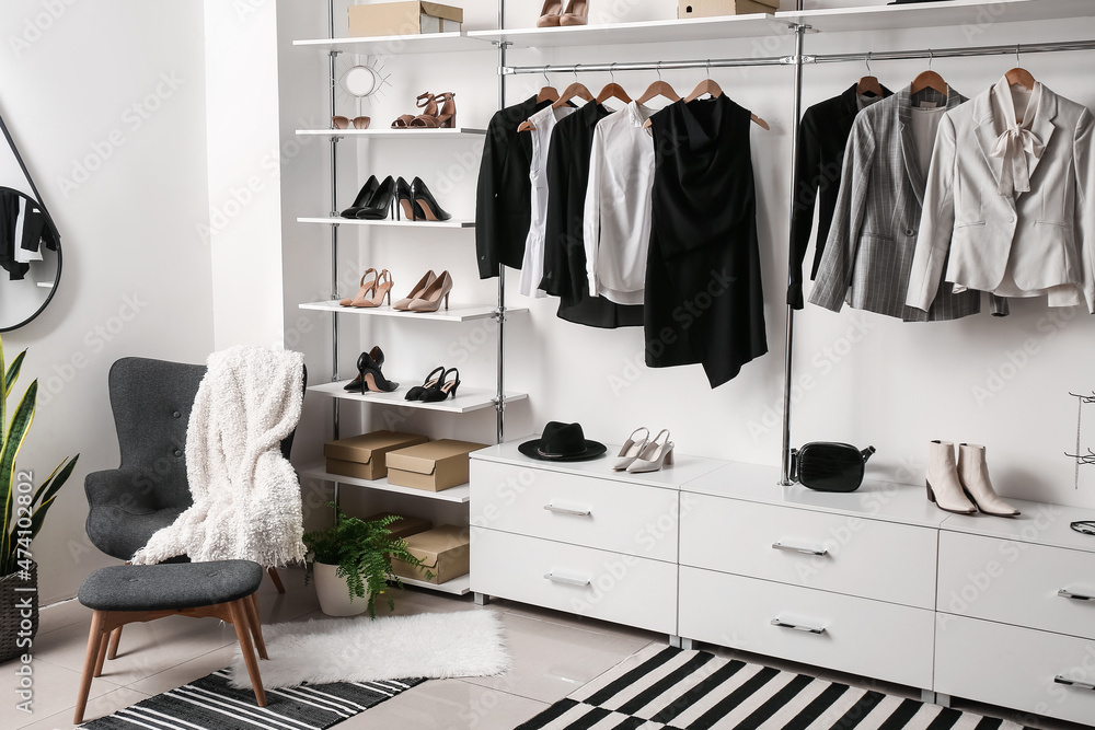Stylish female shoes and clothes in wardrobe