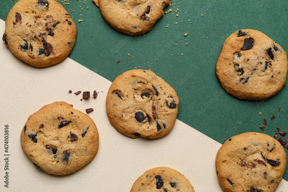 Delicious homemade cookies with chocolate chips on color background