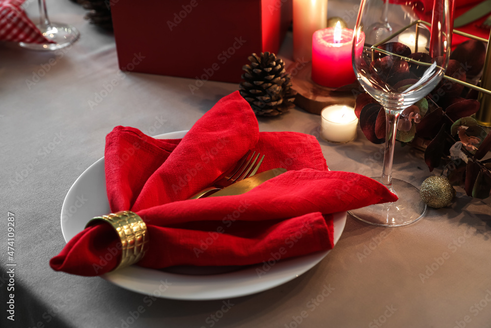 Plate with napkin on table decorated for Christmas, closeup
