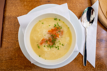 Wall Mural - Seasonal dish, white asparagus cream soup with smoked salmon fish