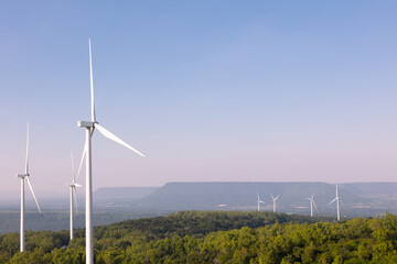  Many wind turbines in rows located with beautiful landscape on the hill with blue sky are operating to generate electric power which is the alternative energy resource for sustainable power supply.