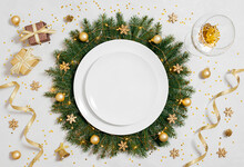Christmas Table Setting With Empty White Plate And Gold Decorations On Gray Table. Copy Space, Top View, Flat Lay.