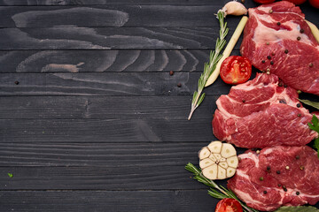 meat on wooden board vegetables and ingredients for cooking wooden background