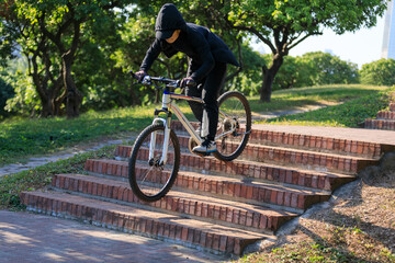 Wall Mural - Woman free rider riding bike going down city stairs