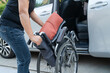 © amazing studio - Asian woman folding and lift up wheelchair into her car. Accessibility concept.