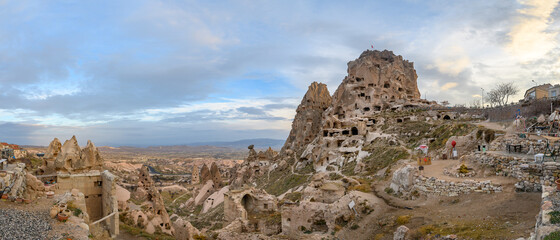 Wall Mural - Uchisar Castle, town in Cappadocia, Turkey near Goreme. Panorama of Cappadocia landscape and valley with ancient rock formation and caves.