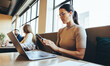 © Jacob Lund - Businesswoman reading a text message in a co-working space