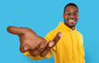 © Prostock-studio - Happy black guy showing big outstretched hand, offering help, taking or giving something, reaching out for support