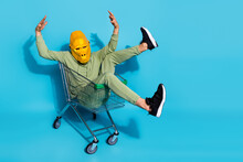 Photo Of Funky Funny Guy Dressed Wild Animal Mask Riding Shopping Trolley Isolated Blue Color Background