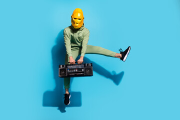 Sticker - Photo of funky handsome guy jump hold tape recorder wear gorilla mask isolated blue color background