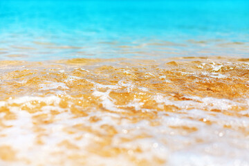 Wall Mural - Blue sea wave texture close up, turquoise ocean, transparent water surface, white foam, golden yellow sand, sunny beach, tropical island, natural background, summer holidays backdrop, vacation design