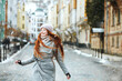Emotional red head woman walking at the street during winter vacation