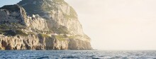 Rocky Shores (cliffs, Mountains) Of The Europa Point, A View From The Sailing Boat. Gibraltar, British Overseas Territory. Travel Destinations, National Landmark, Sightseeing Theme
