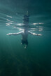 © raland - Man swimming in a blue sea. Young man bathing and relaxing in the clear and transparent sea water.
