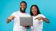 © Prostock-studio - Black couple using laptop pointing fingers at gadget
