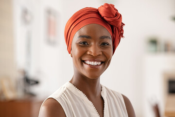 Smiling mature black woman with african headscarf