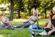 © Drobot Dean - Multiracial women talking and smiling during yoga practice in park