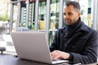 © ADDICTIVE STOCK - Businessman browsing laptop in cafe