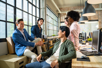 Happy multiracial young people friends talking laughing at group meeting,diverse students drinking coffee having fun together enjoy multi-ethnic friendship pleasant conversation in modern office.