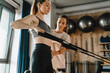© Drobot Dean - White woman working out on exercise machine during pilates class