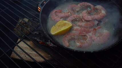 Wall Mural - Shrimps with lemon in a frying pan on the grill