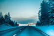 Winter asphalt road.  Winter road and trees with snow and Latvian landscape. Soft focus on photos.