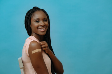 Vaccinated attractive young woman with plaster on hand