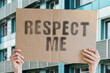 © AndriiKoval - The phrase ' Respect me ' on a banner in men's hand with blurred background. Morality. Respect others. People. Egoistical. Egoistic. Strike. Fight. Collision. Conflict. Relationship. Social issues