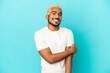 © luismolinero - Young Colombian handsome man isolated on blue background laughing