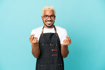 Poster - Restaurant Colombian waiter man isolated on blue background making money gesture