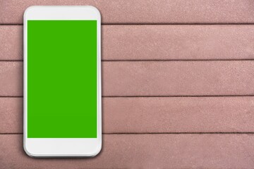 Sticker - Blank green screen on a smartphone on a background.