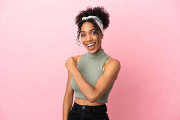 Canvas Print - Young latin woman isolated on pink background celebrating a victory