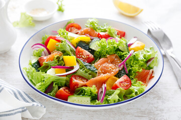 Wall Mural - Salted salmon salad with fresh green lettuce, cucumbers, tomato, bell pepper and red onion. Ketogenic, keto or paleo diet lunch bowl