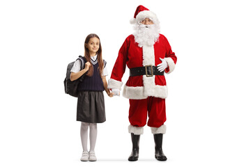 Sticker - Full length portrait of santa claus holding hand of a girl in a school uniform with a backpack