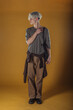 © qunica.com - Portrait of a smart young man standing against yellow backgroun