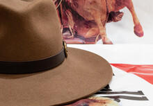 Classic Cowboy Brown Felt Hat With Strap And Copper Closure On Background Of Poster With Horse