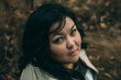 © Cavan Images - Beautiful plus size asian girl is resting in nature. autumn day