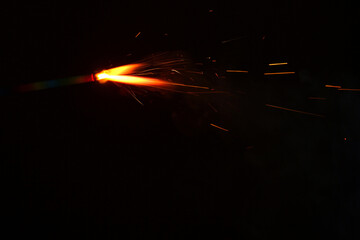 Wall Mural - a sparkler is a type of hand held firework that burns slowly while emitting bright, intense colored 