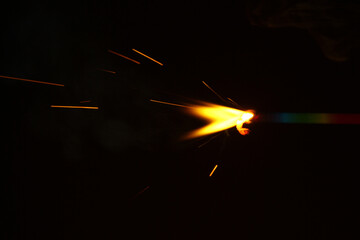 Wall Mural - a sparkler is a type of hand held firework that burns slowly while emitting bright, intense colored 