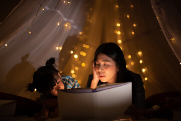 Wall Mural - young Asian mother with little child daughter family happy in cozy night light at childhood home