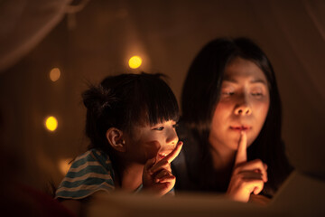 Wall Mural - young Asian mother with little child daughter family happy in cozy night light at childhood home